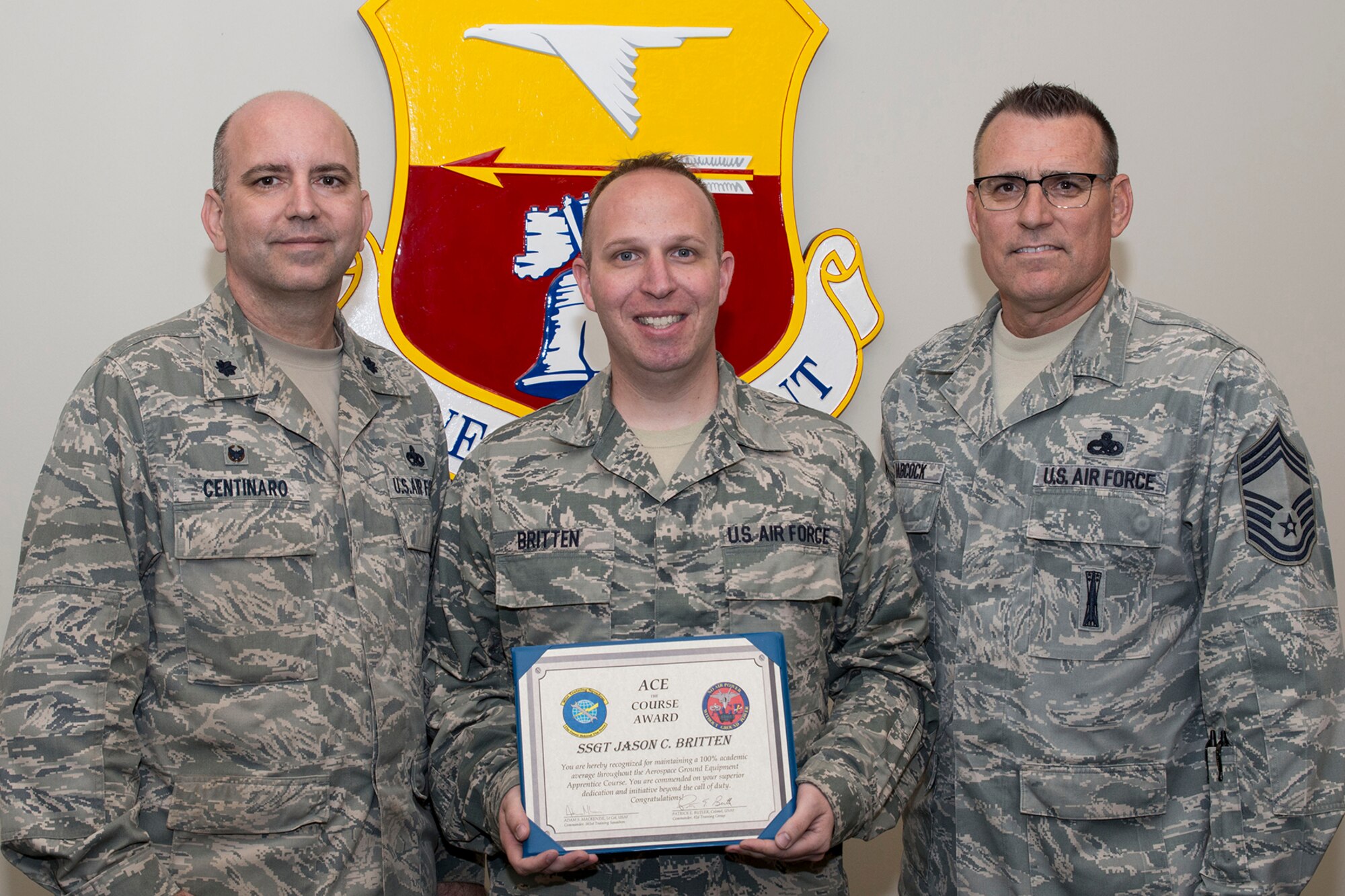 U.S. Air Force Reserve Lt. Col. Paul Centinaro, commander, 913th Maintenance Squadron, Staff Sgt. Jason C. Britten, aerospace ground equipment apprentice, 913 MXS, and Chief Master Sgt. Ralph E. Babcock II, superintendent, 913th Aircraft Maintenance Squadron, pose for a photo at Little Rock Air Force Base, Ark., April 5, 2017. Britten received the prestigious ACE Award March 20, 2017, while training at Sheppard AFB, Texas. The ACE award is earned by maintaining a perfect 100 percent on all tests and evaluations through an entire course. (U.S. Air Force photo by Master Sgt. Jeff Walston/Released)