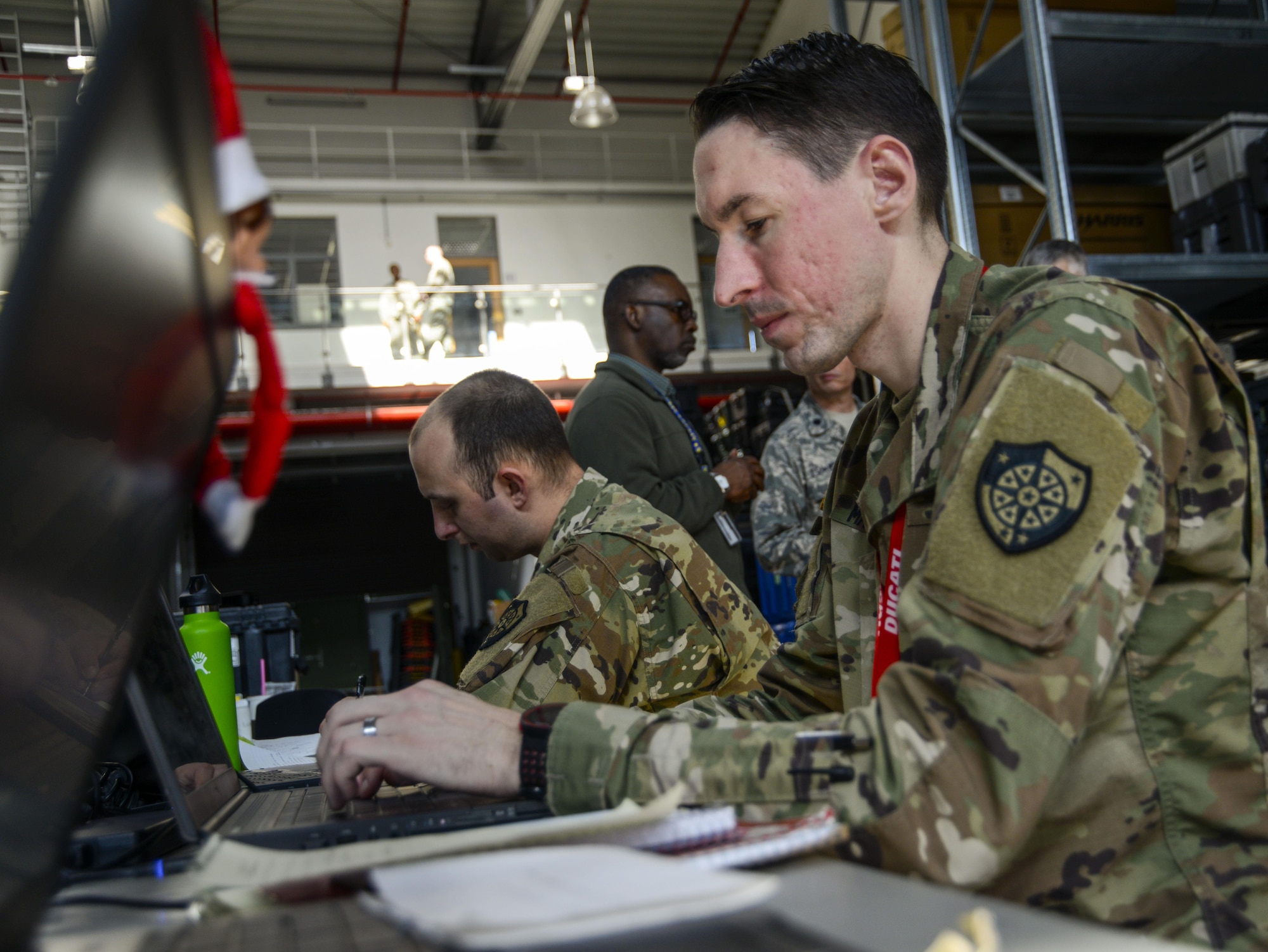U.S. Army Staff Sgt. Matthew Malesinski, right, 201st Cyber Protection Team network security analyst, reviews data his team collected during a cyber security audit of the 1st Combat Communications Squadron’s tactical communications kits March 16, 2017, on Ramstein Air Base, Germany. Representing the U.S. Army Cyber Protection Brigade, the members of the 201st CPT tested physical and internal security of the 1st CBCS’ communications kits. The data they collected will be given to 1st CBCS leaders to help their operators increase the security of their systems. (U.S. Air Force photo/Staff Sgt. Timothy Moore)