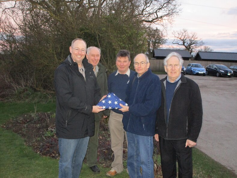 Col. David Berg, 55th Wing vice commander, presents a U.S. flag to a group of locals to be placed at the former runway at
U.S. Army Air Forces station 131 in Nuthampstead, England. The abandoned airfield was home to the 55th Pursuit Group during World War II. (Courtesyphoto)
