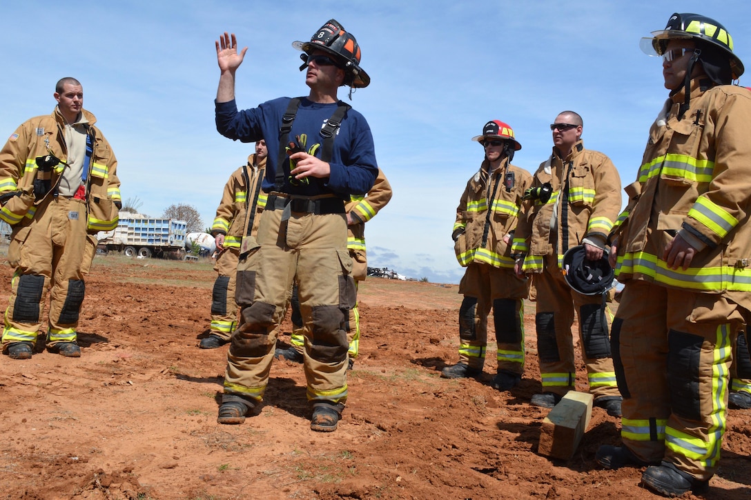 Oklahoma City Fire Department Lt. Steve Long, center, instructs airmen during a heavy vehicle extrication exercise at Eastern Oklahoma County Technology Center in Choctaw, Okla., March 31, 2017. The airmen are firefighters assigned to 507th Civil Engineer Squadron. Long is an Instructor at the Eastern Oklahoma County Technology Center. The exercise taught firefighters how to rescue personnel from vehicles such as armored Humvees or Mine-Resistant Ambush Protected vehicles. Air Force photo by Master Sgt. Grady Epperly