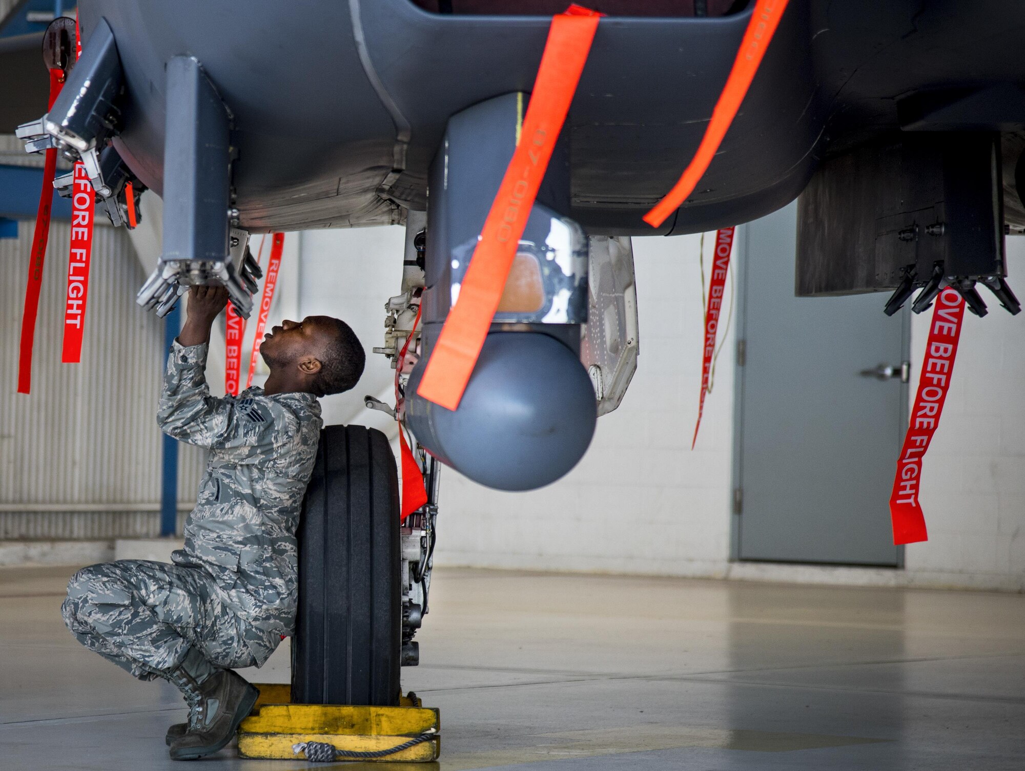 Senior Airman Aubrey Sloan, 96th Aircraft Maintenance Squadron Red, performs preloading checks at the beginning of the Team Eglin weapons load competition April 7 at Eglin Air Force Base, Fla.  Teams from the 96th Test Wing and 33rd Fighter Wing competed to see who could load up two weapons onto their designated aircraft the quickest and with the fewest errors.  The 33rd FW team repeated as base champion.  (U.S. Air Force photo/Samuel King Jr.)