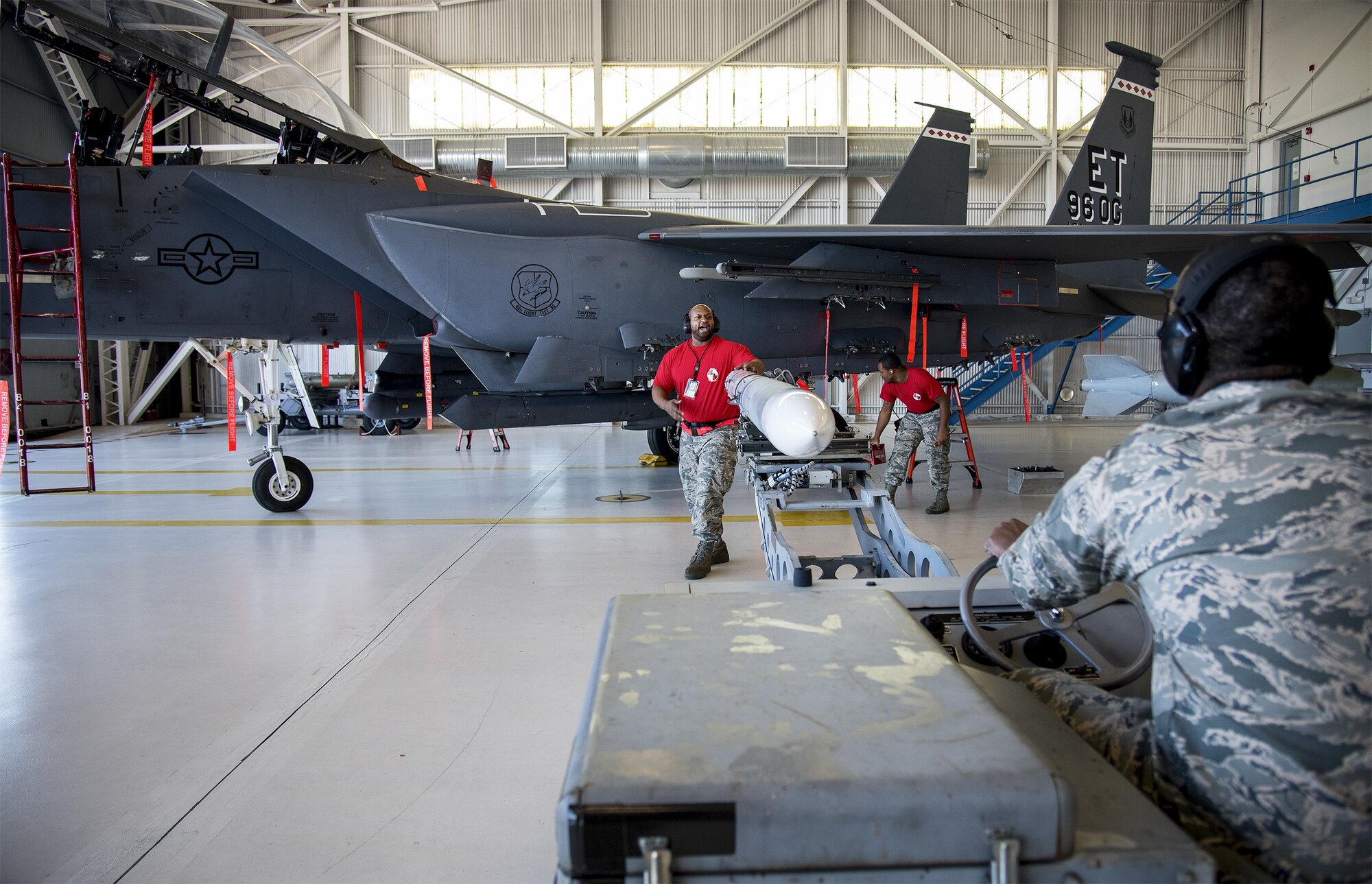 Staff Sgt. Damon Bryant, 96th Aircraft Maintenance Squadron Red, directs an AIM-120 missile toward an F-15 during the Team Eglin weapons load competition April 7 at Eglin Air Force Base, Fla.  Teams from the 96th Test Wing and 33rd Fighter Wing competed to see who could load up two weapons onto their designated aircraft the quickest and with the fewest errors.  The 33rd FW team repeated as base champion.  (U.S. Air Force photo/Samuel King Jr.)