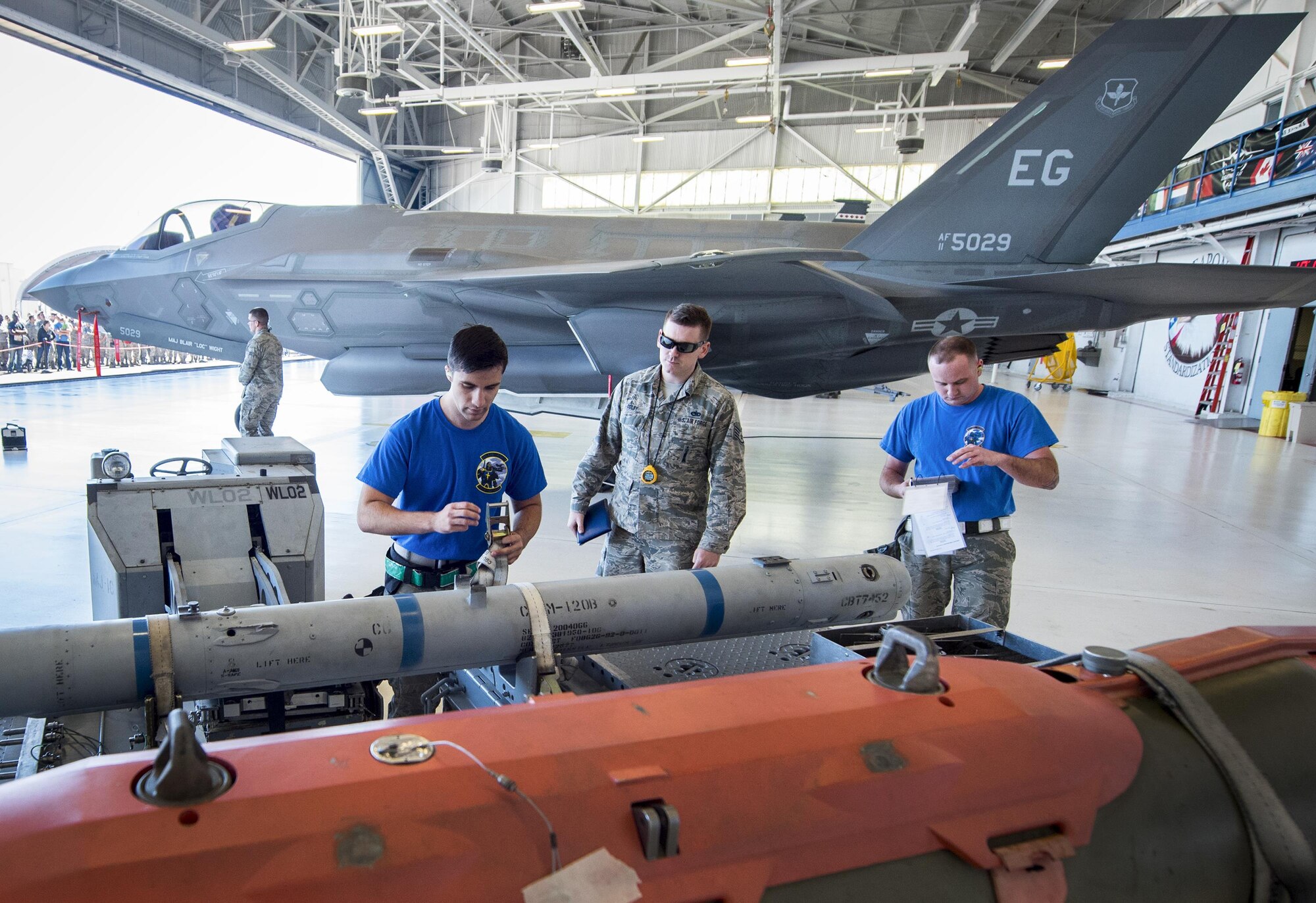 The 96th Aircraft Maintenance Squadron Blue team begins the preparation of the AIM-120 missile for loading during the Team Eglin weapons load competition April 7 at Eglin Air Force Base, Fla.  Teams from the 96th Test Wing and 33rd Fighter Wing competed to see who could load up two weapons onto their designated aircraft the quickest and with the fewest errors.  The 33rd FW team repeated as base champion.  (U.S. Air Force photo/Samuel King Jr.)