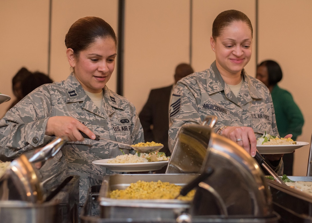 Capt. Janise Rivera, National Guard Bureau assistant chief, left, and Master Sgt. Laketia Abercrombie, National Guard Bureau program manager, right, collect food from a buffet during the National Prayer Luncheon at Joint Base Andrews, Md., April 4, 2017. The event consisted of group prayer, a meal, music by the U.S. Air Force Band, and a speech made by Brig. Gen. J. Steven Chisolm, Air National Guard Assistant to the U.S. Air Force Chief of Chaplains. (U.S. Air Force photo by Senior Airman Jordyn Fetter)