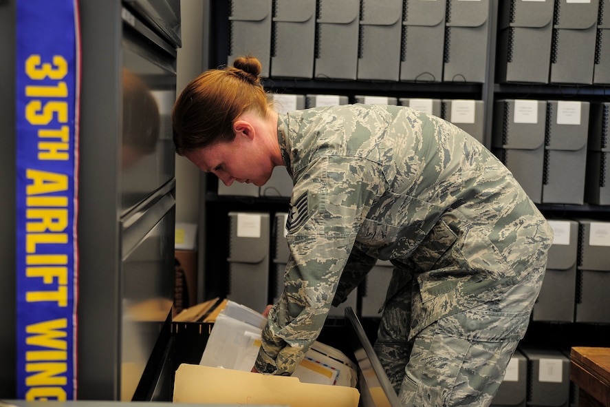 Tech. Sgt. Brooke Howells, 315th Airlift Wing historian, sorts documents from past events April 8, 2017 at Joint Base Charleston, S.C. (U.S. Air Force photo by Senior Airman Jonathan Lane).