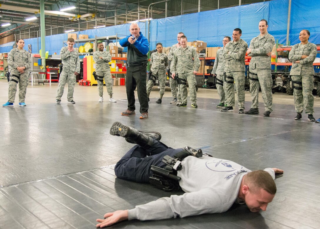 Cpl. Jason Baxley, Delaware State Police Tactical Control Unit defensive tactics instructor, demonstrates giving verbal commands to a suspect before placing them in custody April 6, 2017, at Dover Air Force Base, Del. This technique helps to minimize threat to officers from a potential hidden weapon. Baxley, who also serves as the medic for the TCU, was one of 30 Delaware State Police Officers who trained with Dover AFB security forces members. (U.S. Air Force photo by Mauricio Campino)