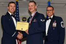 U.S. Air Force Reserve Maj. Grady Dieckert, commander, 913th Operations Support Squadron, Senior Airman Quinton Reinhardt, operations intelligence technician, 913 OSS, and Chief Master Sgt. Ralph Babcock III, superintendent, 913th Aircraft Maintenance Squadron, pose for a photo during the Airman Leadership School (ALS) graduation ceremony at Little Rock Air Force Base, Ark., April 6, 2017. ALS is an Air Force education program held at base level to prepare senior Airmen for positions of greater responsibility. The course teaches leadership skills required of supervisors and reporting officials throughout the Air Force. (U.S. Air Force photo by Airman 1st Class Kevin Sommer Giron)