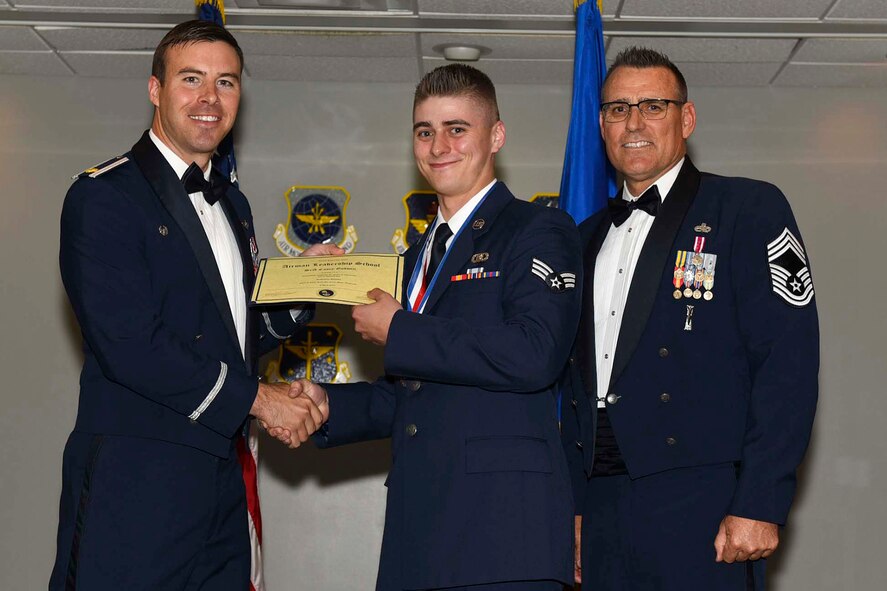 U.S. Air Force Reserve Maj. Grady Dieckert, commander, 913th Operations Support Squadron, Senior Airman Casey Godwin, aircrew flight equipment, 913th Maintenance Squadron, and Chief Master Sgt. Ralph Babcock III, superintendent, 913th Aircraft Maintenance Squadron, pose for a photo during the Airman Leadership School (ALS) graduation ceremony at Little Rock Air Force Base, Ark., April 6, 2017. ALS is an Air Force education program held at base level to prepare senior Airmen for positions of greater responsibility. The course teaches leadership skills required of supervisors and reporting officials throughout the Air Force. (U.S. Air Force photo by Airman 1st Class Kevin Sommer Giron)