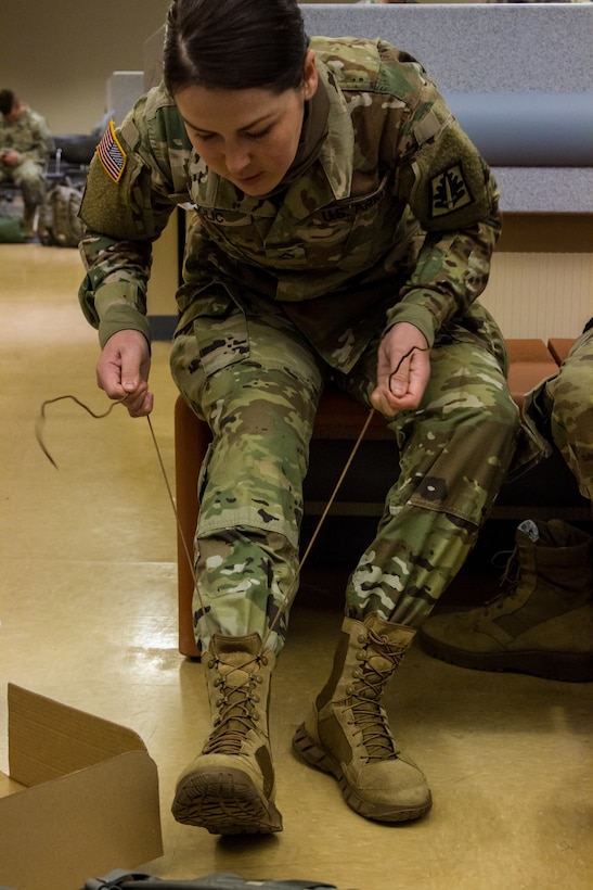 US Army Pvt. First Class Hurija Colic, a unit supply specialist with the 400th Military Police Batallion, 200th Military Police Command, laces her boots after trying on a set of cold weather boots issued by the Fort McCoy, Wis. Central Issue Facility in preparation for training and qualification during Operation Cold Steel, April 03, 2017. The 200th MPC has oversight of four brigades, 22 battalions and 53 companies dispersed across the continental US. Operation Cold Steel is the U.S. Army Reserve’s crew-served weapons qualification and validation exercise to ensure that America’s Army Reserve units and Soldiers are trained and ready to deploy on short-notice and bring combat-ready, lethal firepower in support of the Army and our joint partners anywhere in the world. (U.S. Army Reserve photo by Spc. Jeremiah Woods, 358th Public Affairs Detachment / Released)