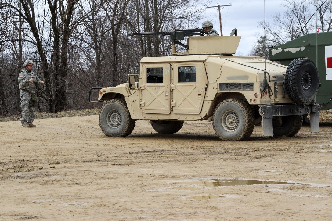 Army Reserve Spc. Carlos Santos Martinez, from the 430th Quartermaster Company, based out of Fort Buchanan, Puerto Rico, guides his team’s Humvee during Operation Cold Steel at Fort McCoy, Wis., on March 31, 2017. The company is assigned to the 1st MSC, based out of Fort Buchanan, Puerto Rico, which provides mission command to assigned units of the Army Reserve in Puerto Rico and the U.S. Virgin Islands to ensure unit readiness to deploy to war and successfully execute their wartime missions. Operation Cold Steel is the U.S. Army Reserve’s crew-served weapons qualification and validation exercise to ensure that America’s Army Reserve units and Soldiers are trained and ready to deploy on short-notice and bring combat-ready, lethal firepower in support of the Army and our joint partners anywhere in the world. (U.S. Army Reserve photo by Spc. Jeremiah Woods, 358th Public Affairs Detachment / Released)