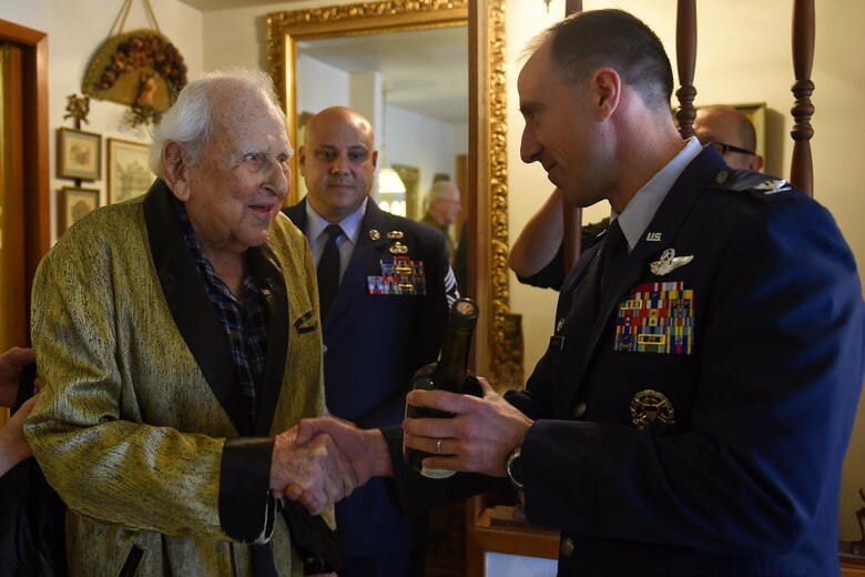 Col. (ret.) Ralph Jenkins (left), World War II 510th Fighter Squadron commander, receives a bottle of 1945 Calvados Brandy from Col. Leonard Kosinski (right), 62nd Airlift Wing commander and Chief Master Sgt. Tico Mazid, 62nd AW command chief at the Jenkins residence in Seattle, April 7, 2017. Jenkins celebrated a virtual toast with Maj. (ret.) M.E. Johns in Lompoc, California as their unit made a pact to do this when there was only two members of their squadron left. (U.S. Air Force photo/Tech. Sgt. Tim Chacon)