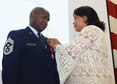 Cheryl Tubbs, wife of Chief Master Sgt Lyndon Tubbs, Command Chief of the 94th Airlift Wing, Dobbins Air Reserve Base, Ga., pins on the retirement pin during his retirement ceremony, honoring a 33 year career on Dobbins April 1, 2012. (U.S. Air Force photo/Don Peek)