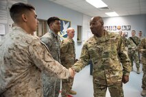 Chief Master Sgt. of the Air Force Kaleth O. Wright shakes hands with Sgt. Brandon Choo at the 407th Expeditionary Security Forces Squadron during his visit to the 407th Air Expeditionary Group April 8, 2017. Choo was recognized for his leaderthip as one of many U.S. Marines integrated into the 407th ESFS to enhance the installation’s security mission. (U.S. Air Force photo/Master Sgt. Benjamin Wilson)(Released)