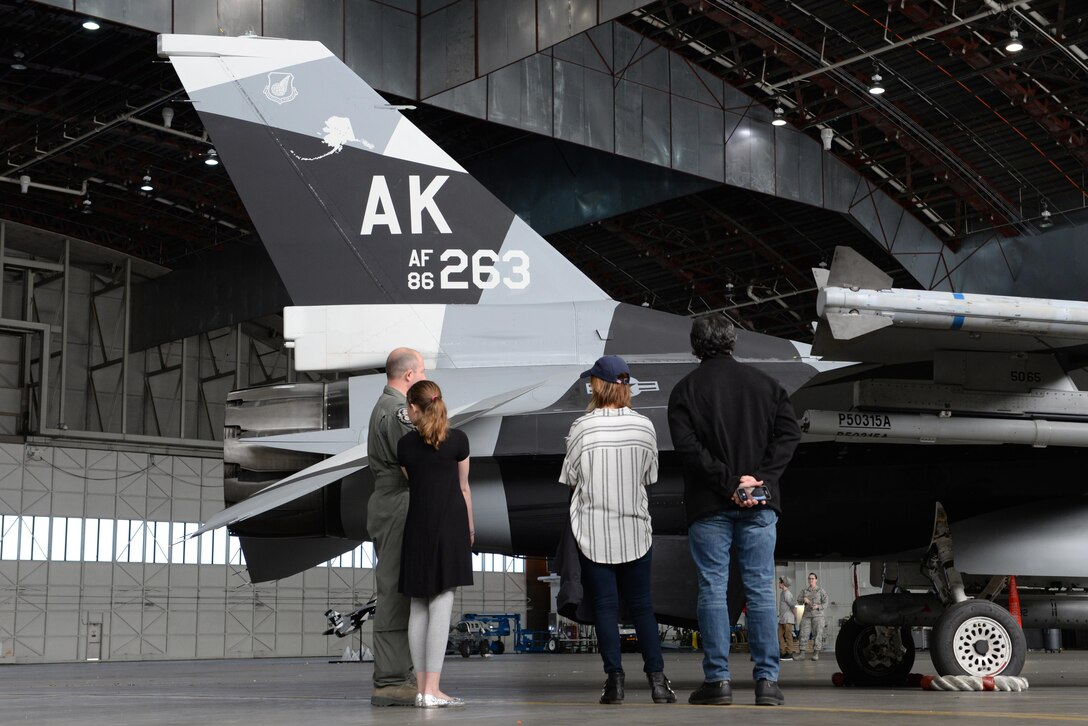 U.S. Air Force Col. Todd Robbins, the 354th Fighter Wing vice commander, speaks with Cassadee Pope and her tour manager about the F-16 Fighting Falcon aircraft April 8, 2017, at Eielson Air Force Base, Alaska. Robbins explained the functions of the F-16 and how it contributes to Eielson’s mission of prepare, deploy and enable. (U.S. Air Force photo by Airman 1st Class Cassandra Whitman)