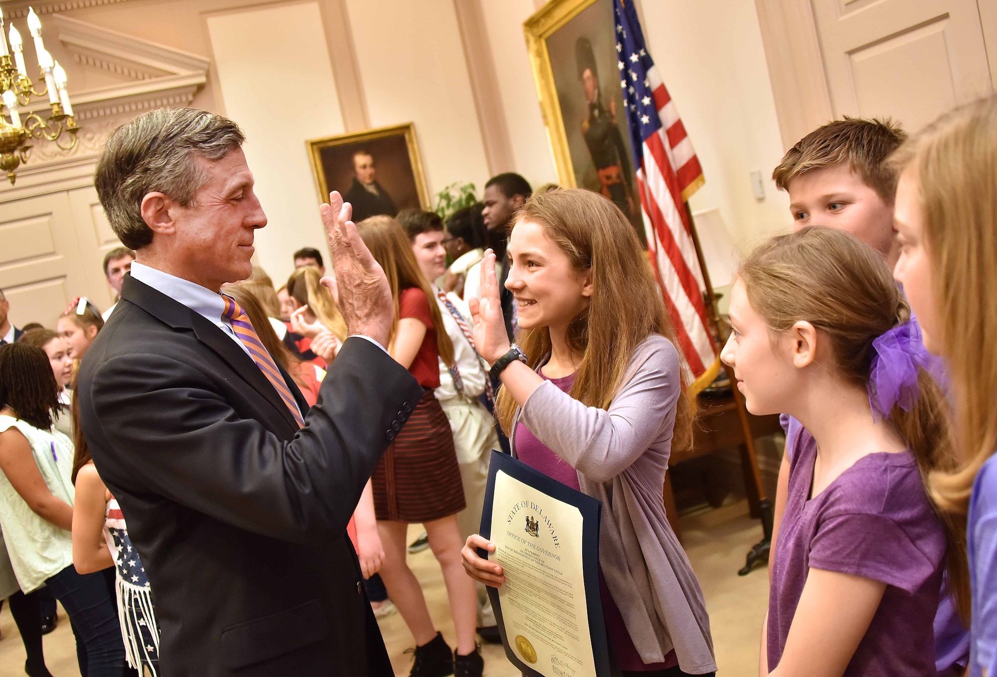 Delaware Gov. John Carney meets with the Dover Air Force Base Middle School Chorus while observing a day of recognition of military children in the First State April 4, 2017, at Legislative Hall in Dover, Del. Carney signed Senate Concurrent Resolution 16, making April 2017 as the Month of the Military Child and April 4, 2017, as the official Day of Recognition of the Military Child in the State of Delaware. (Courtesy photo/David Chambers) 