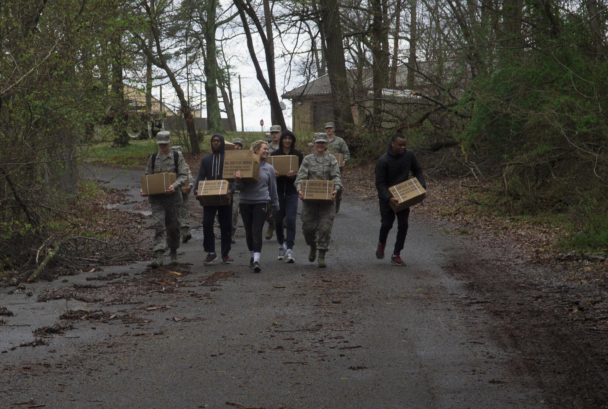 University of Maryland ROTC students carry Meals Ready to Eat during training at Joint Base Andrews, Md., April 1, 2017. The students took a break between practicing entry control point challenging and procedures, combat medical readiness, tactical movements, and land navigation. The training was led by 11th Security Forces Squadron Airmen. (U.S. Air Force photo by Senior Airman Mariah Haddenham)