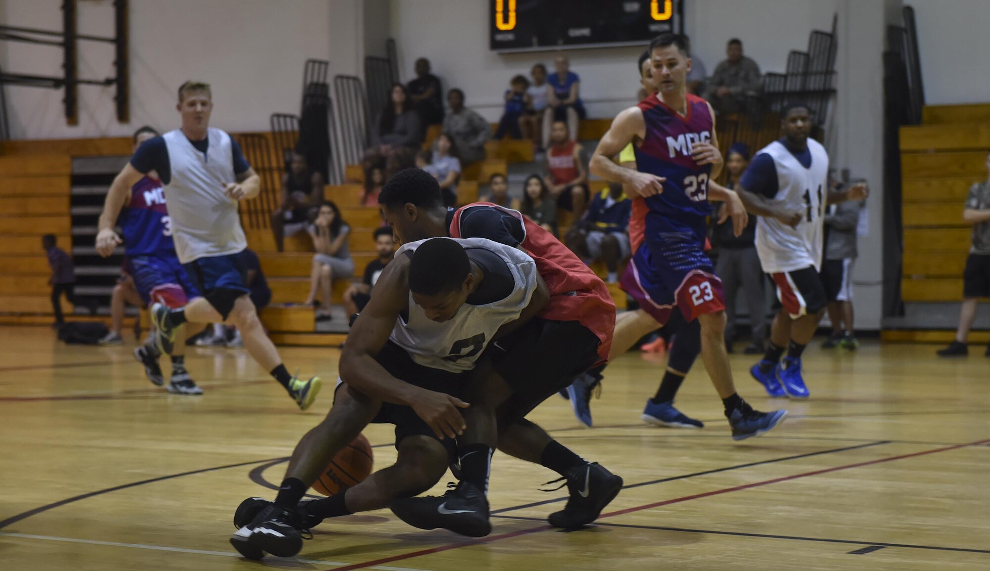 Eric Flowers, a member of the 1st Special Operations Civil Engineer Squadron basketball team, collides with a member of the 1st Special Operations Medical Group basketball team, during the intramural basketball championship at the Aderholt Fitness Center on Hurlburt Field, Fla., April 6, 2017. For eight weeks, 12 teams competed through a single-elimination tournament to qualify for the championship game. (U.S. Air Force photo by Airman 1st Class Joseph Pick)