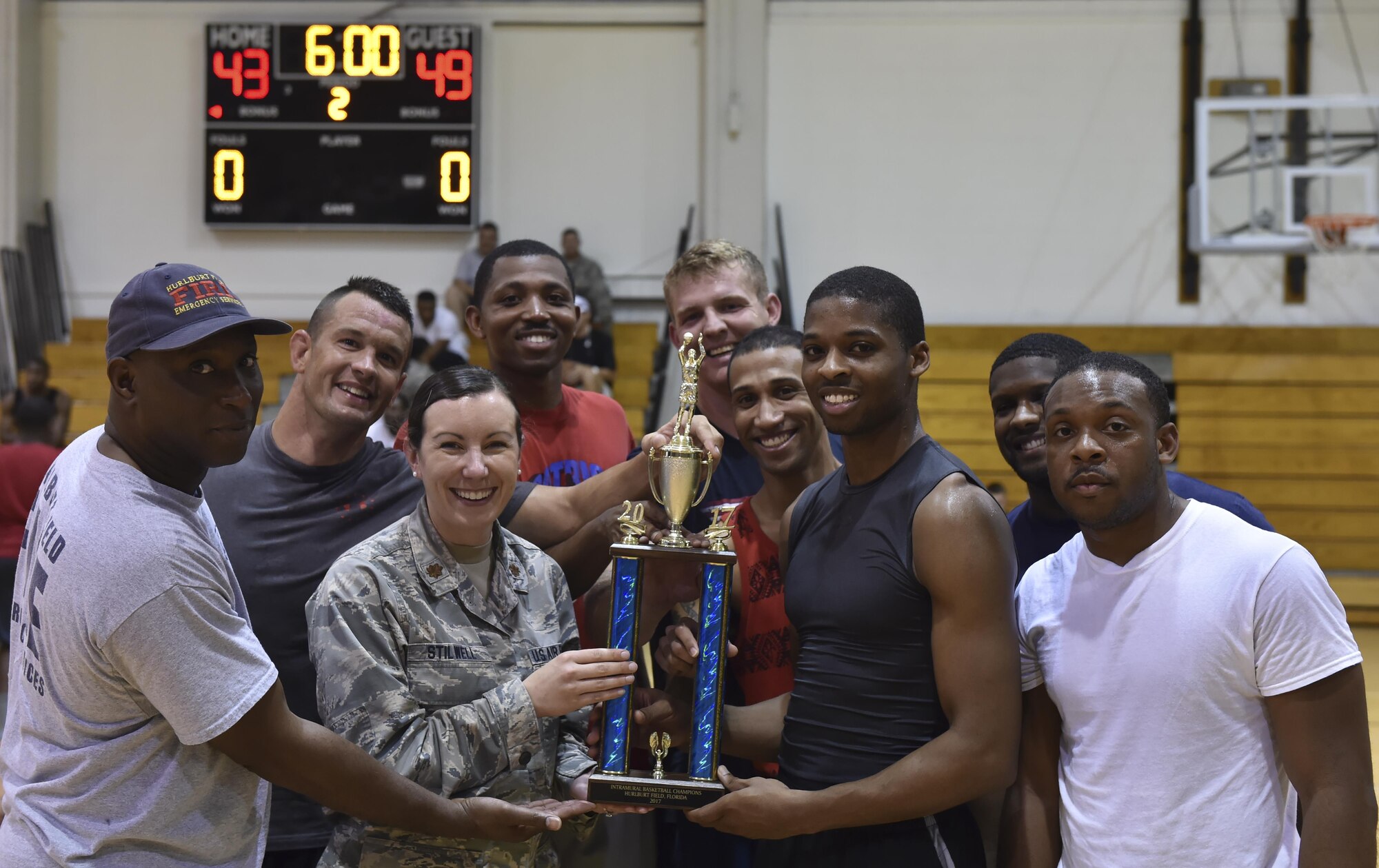 The 1st Special Operations Civil Engineer Squadron basketball team celebrate with the first place trophy after the intramural basketball championship at the Aderholt Fitness Center on Hurlburt Field, Fla., April 6, 2017. The 1st SOCES bested the 1st Special Operations Medical Group by the score of 49 to 43. (U.S. Air Force photo by Airman 1st Class Joseph Pick)