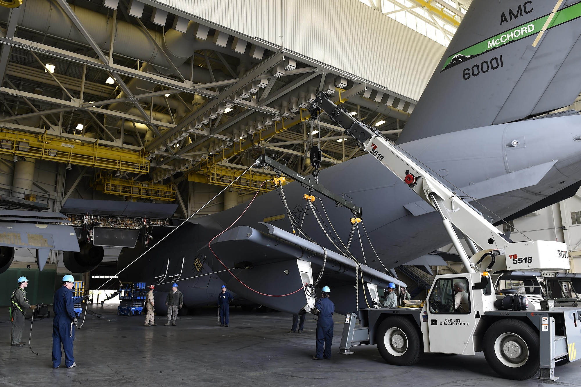 Airmen and civilians from the 62nd Maintenance Squadron move a replacement C-17 Globemaster III flap with a crane April 6, 2017, at Joint Base Lewis-McChord, Wash. The new flap arrived at the base on March 22 and took more than a week to be prepped for the installation. (U.S. Air Force photo/Tech. Sgt. Tim Chacon)  