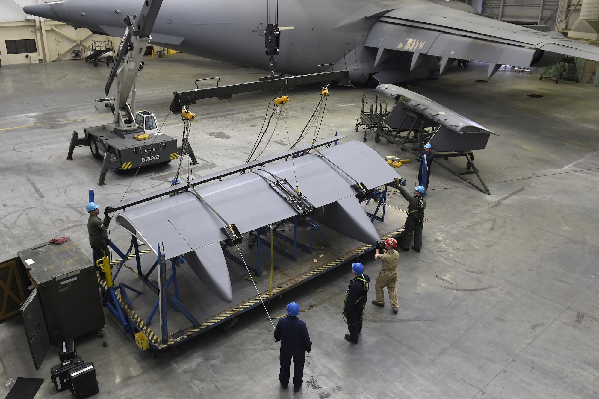 Airmen and civilians from the 62nd Maintenance Squadron hoist a C-17 Globemaster III flap from a stand April 6, 2017, at Joint Base Lewis-McChord, Wash. The 2,200 pound flap replaced a faulty flap and is the first flap change to ever be completed at McChord Field. (U.S. Air Force photo/Tech. Sgt. Tim Chacon)