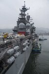 Japanese tugboats tow the amphibious assault ship USS Bonhomme Richard (LHD 6) during port operations, April 10, 2017. Bonhomme Richard, flagship of the Bonhomme Richard Amphibious Ready Group, is returning from a 6-week patrol in the Indo-Asia-Pacific region. 