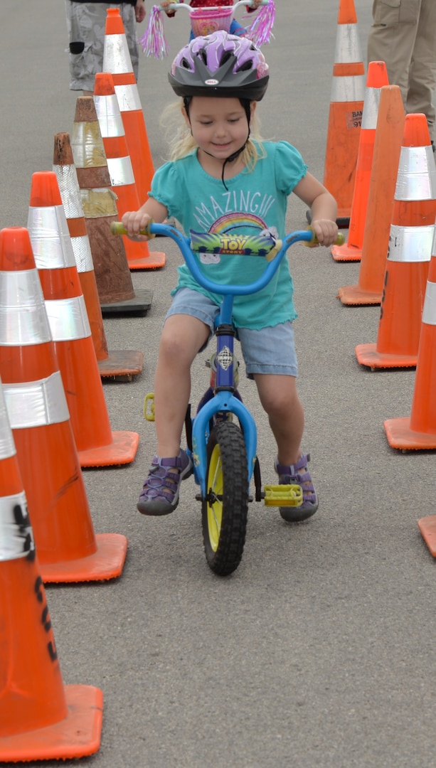 Three-year-old Erika struggled a little bit during the balance obstacle course in making it through the finish line.  Officers encouraged Erika through the course and assisted her during the 2017 Spring Bike Rodeo April 8 at Joint Base San Antonio-Fort Sam Houston.