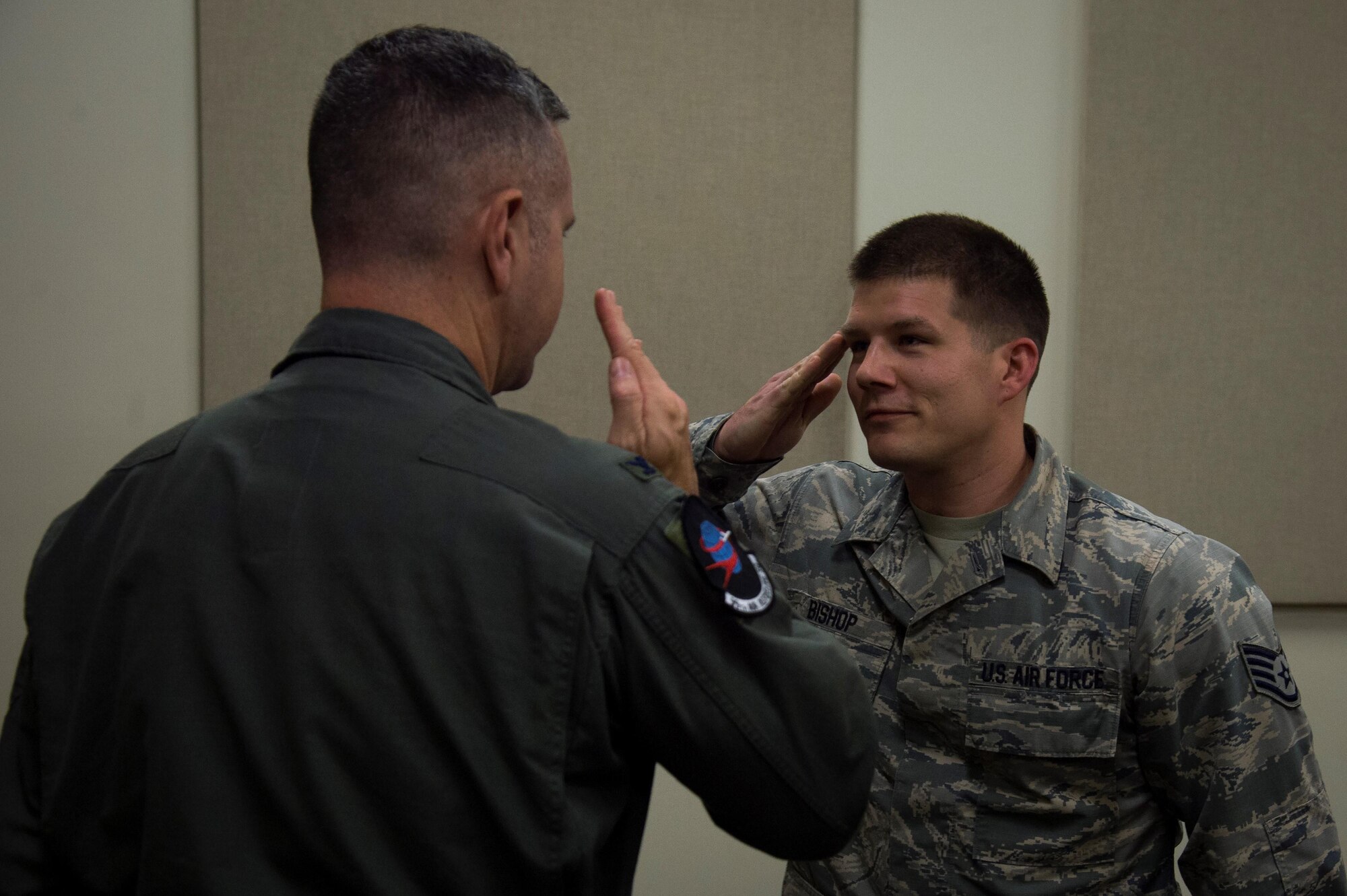 U.S. Air Force Col. William Stowe III, commander of the 6th Operations Group, salutes a 99th Air Refueling Squadron staff sergeant after coining him for being recognized as a top performer during a visit by Stowe and other 6th Air Mobility Wing leadership April 4, 2017. Stowe, although stationed at MacDill, is the operations group commander over the 99th ARS on Birmingham Air National Guard Base, Ala.