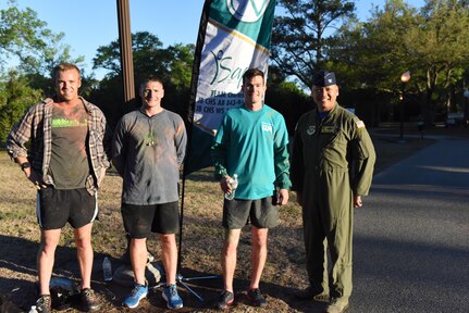 The top three finishers of the base's color run hosted by the Sexual Assault Prevention and Response office pose with Col. Jimmy Canlas, 437th Airlift Wing commander, at Joint Base Charleston, South Carolina April 7, 2017. The run was held as part of Sexual Assault Awareness and Prevention Month, which focuses on creating an appropriate culture to eliminate sexual assault.