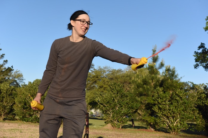 Airman 1st Class Kristen Heller, 1st Combat Camera Squadron photojournalist, sprays colored chalk into the air during a color run hosted by the Sexual Assault Prevention and Response office, at Joint Base Charleston, South Carolina April 7, 2017. The run was held as part of Sexual Assault Awareness and Prevention Month, which focuses on creating an appropriate culture to eliminate sexual assault.