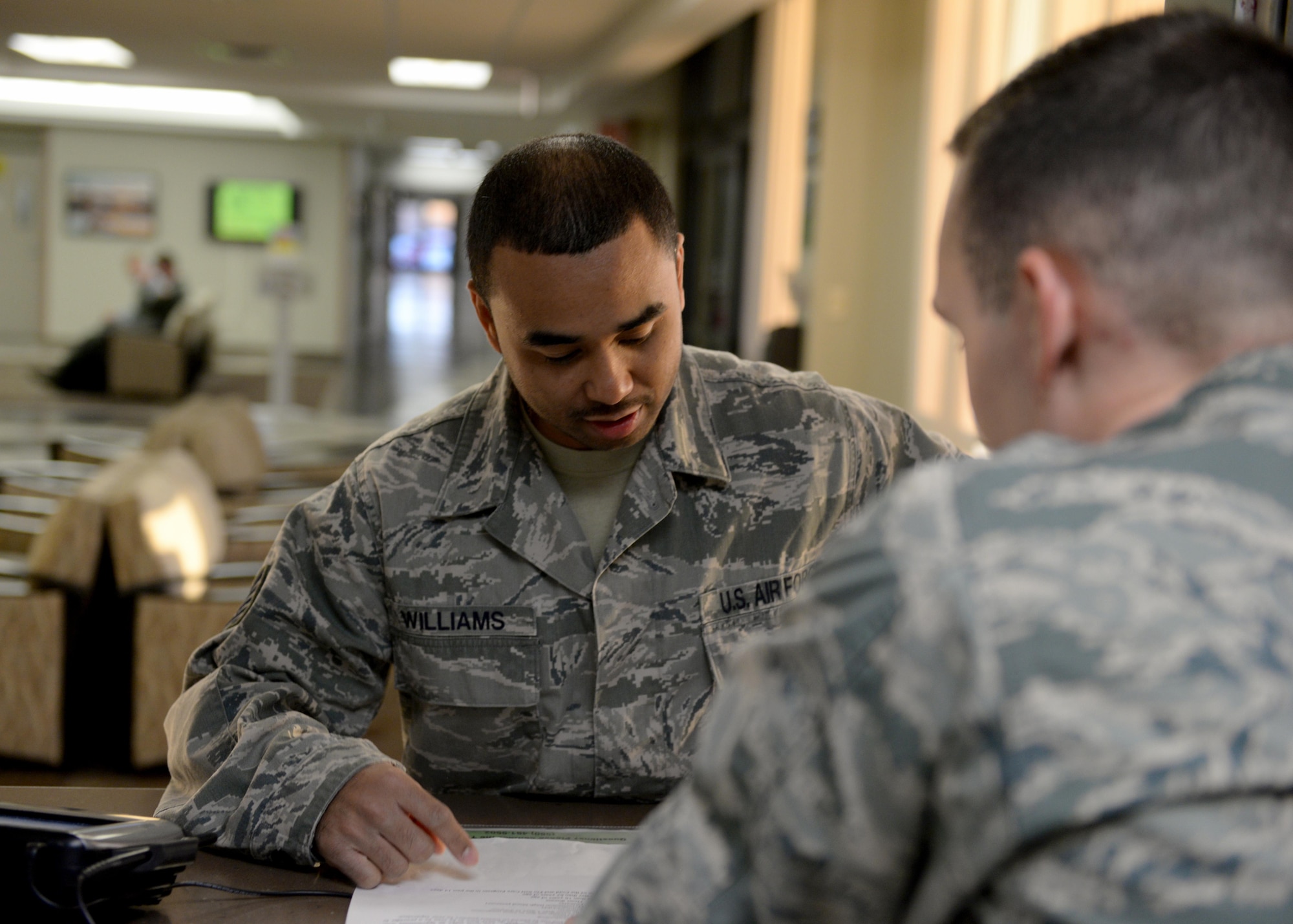U.S. Air Force Tech Sgt. Eric Williams, 97th Medical Support Squadron NCO in charge of the base pharmacy, fills out a sheet to get a cold medication packs, April 10, 2017, at Altus Air Force Base, Oklahoma. The base pharmacy offers cold medication packs to those who meet their qualifications to help cut down on patient and health care provider’s time and money. (U.S. Air Force Photo by Airman 1st Class Jackson N. Haddon/Released).