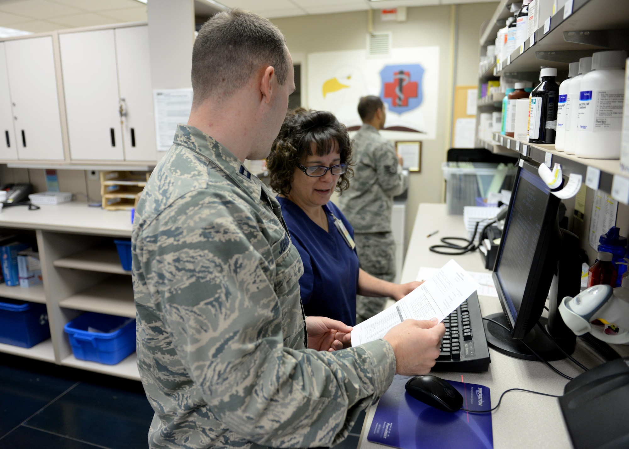 Members of the Altus Air Force Base pharmacy prepare a cold medication pack, April 10, 2017, at Altus Air Force Base, Oklahoma. The base pharmacy offers cold medication packs to those who meet their qualifications to help cut down on patient and health care provider’s time and money. (U.S. Air Force Photo by Airman 1st Class Jackson N. Haddon/Released).