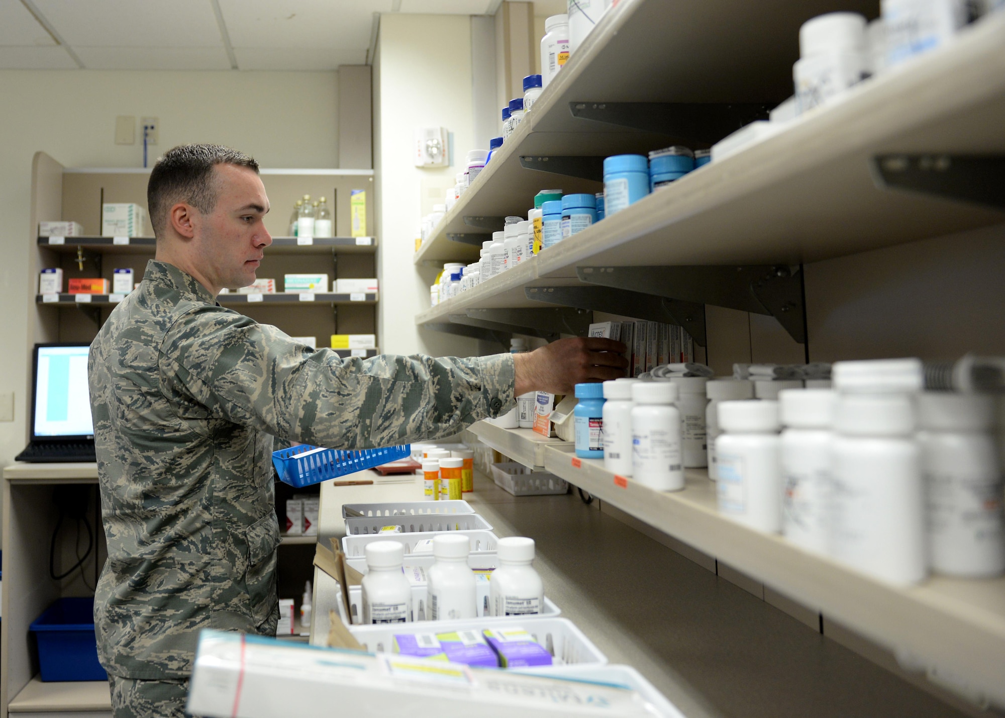 U.S. Air Force Capt. Michael Johnson, 97th Medical Support Squadron pharmacist, assembles a cold medication pack, April 10, 2017, at Altus Air Force Base, Oklahoma. The base pharmacy offers cold medication packs to those who meet their qualifications to help cut down on patient and health care provider’s time and money. (U.S. Air Force Photo by Airman 1st Class Jackson N. Haddon/Released).