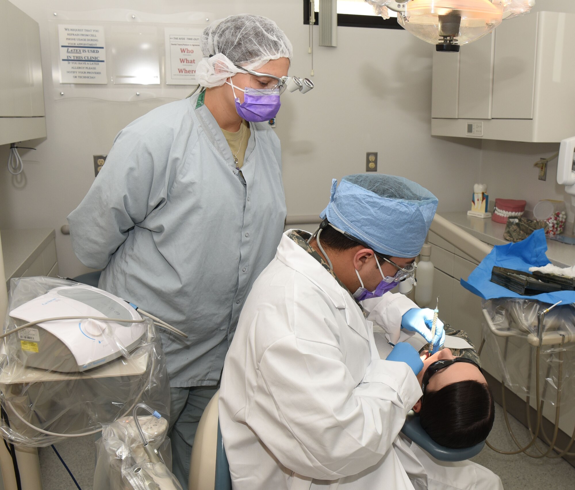 Staff Sgt. Richard Rodriguez, 90th Medical Operations Squadron dental support NCO in charge, instructs Senior Airman Tristan Crosswhite, 90th MDOS dental assistant, during a teeth cleaning at F.E. Warren Air Force Base, Wyo., April 6, 2017. Rodriguez said he enjoys working with Airmen and providing assistance. (U.S. Air Force photo by Airman 1st Class Breanna Carter)