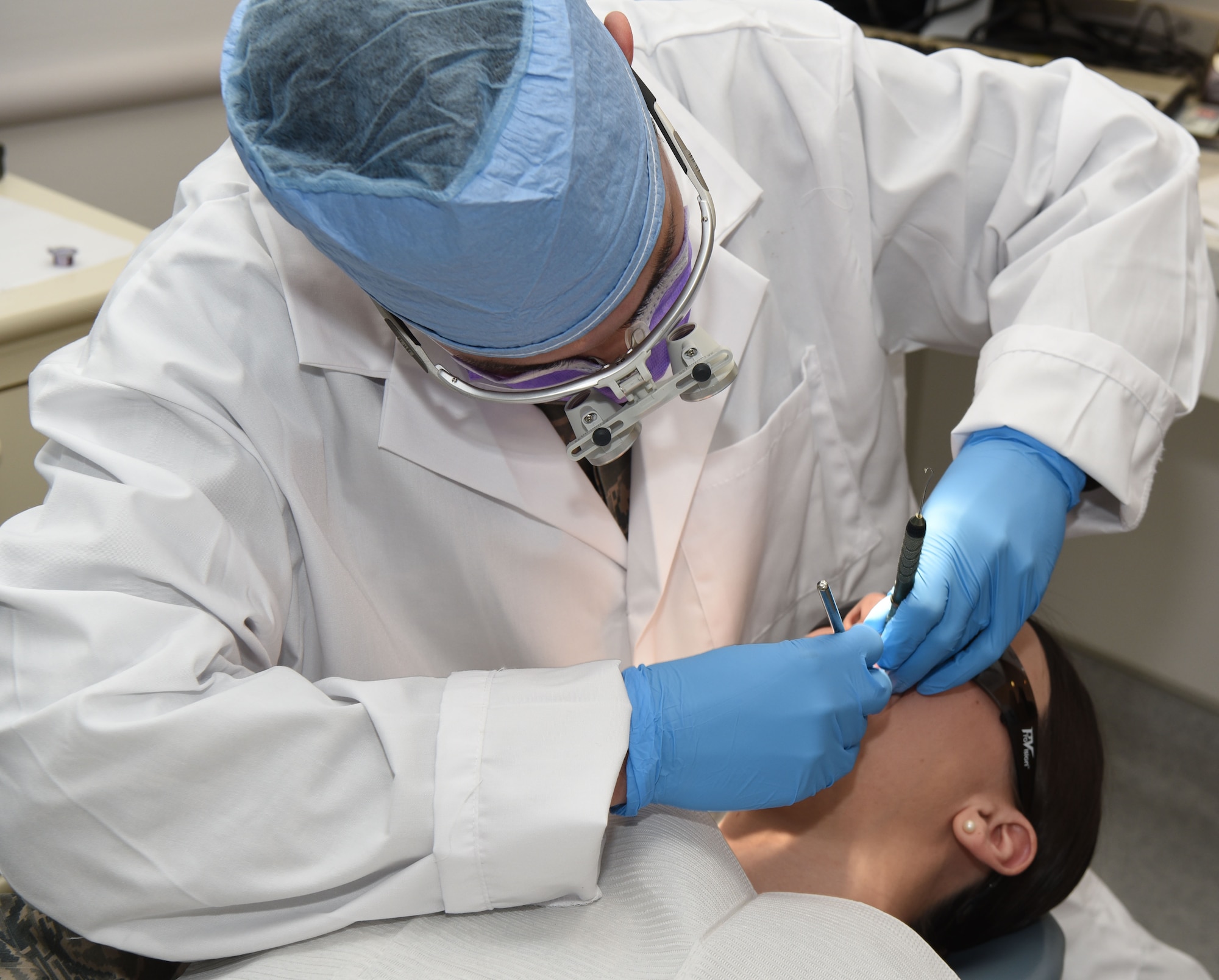 Staff Sgt. Richard Rodriguez, 90th Medical Operations Squadron dental support NCO in charge, checks a patient’s teeth at F.E. Warren Air Force Base, Wyo., April 6, 2017. The dental clinic is focused on achieving superior oral health and mission readiness through safe, effective and patient-centered care. (U.S. Air Force photo by Airman 1st Class Breanna Carter)