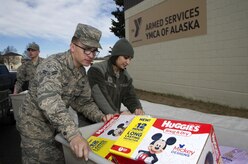 Airmen from the 301st and 381st intelligence squadrons donate close to 4,000 items of canned food and other family needs to the Armed Services YMCA of Alaska at Joint Base Elmendorf-Richardson, Alaska, April 6, 2017. The two squadrons had a friendly competition to donate the most. 