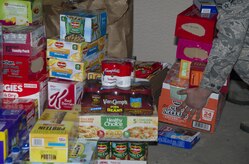 Airmen from the 301st and 381st intelligence squadrons donate close to 4,000 items of canned food and other family needs to the Armed Services YMCA of Alaska at Joint Base Elmendorf-Richardson, Alaska, April 6, 2017. The two squadrons had a friendly competition to donate the most. 