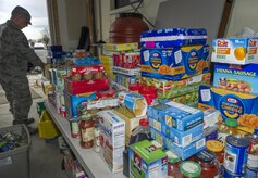 Airmen from the 301st and 381st intelligence squadrons donate close to 4,000 items of canned food and other family needs to the Armed Services YMCA of Alaska at Joint Base Elmendorf-Richardson, Alaska, April 6, 2017. The two squadrons had a friendly competition to donate the most. 