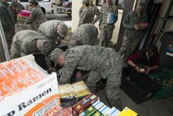 Airmen from the 301st and 381st intelligence squadrons donate close to 4,000 items of canned food and other family needs to the Armed Services YMCA of Alaska at Joint Base Elmendorf-Richardson, Alaska, April 6, 2017. The two squadrons had a friendly competition to donate the most. 