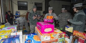 Airmen from the 301st and 381st intelligence squadrons donate close to 4,000 items of canned food and other family needs to the Armed Services YMCA of Alaska at Joint Base Elmendorf-Richardson, Alaska, April 6, 2017. The two squadrons had a friendly competition to donate the most. 