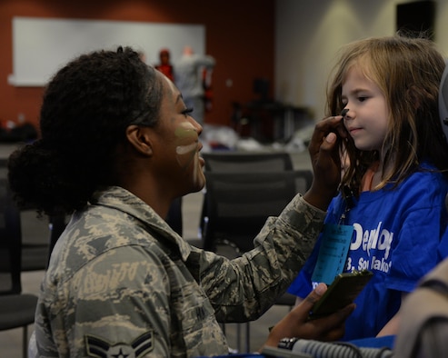 Airman 1st Class Deja Hunter, an aircrew flight equipment specialist assigned to the 28th Operations Support Squadron, paints the nose of a child going through the Kid’s Deployment Line at Ellsworth Air Force Base, S.D., April 8, 2017. Airmen from the 28th OSS painted faces and brought flight equipment for children to try on and use. (U.S. Air Force photo by Airman Nicolas Z. Erwin)