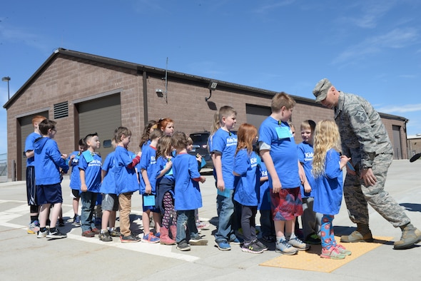Master Sgt. Jason Cast, the first sergeant assigned to the 28th Security Forces Squadron, places children into a formation before they enter the deployment center on Ellsworth Air Force Base, S.D., April 8, 2017. Cast marched the groups of children participating in the Kid’s Deployment Line to and from the deployment center to simulate being deployed.  (U.S. Air Force photo by Airman Nicolas Z. Erwin)