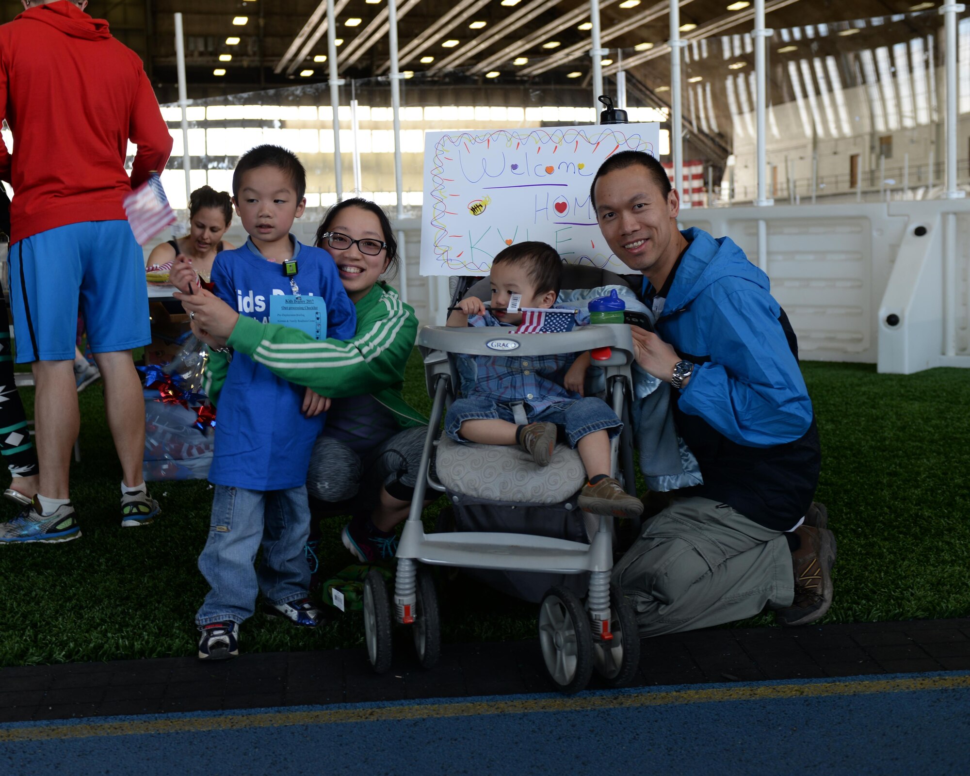 Tech. Sgt. Huy Nguyen, right, a senior weapons system controller assigned to the 28th Maintenance Group, and his family welcome his son back from the deployment center during the Kid’s Deployment Line event at Ellsworth Air Force Base, S.D., April 8, 2017. This is the first time the Nguyens have participated in this event with their oldest son, Kyle. (U.S. Air Force photo by Airman Nicolas Z. Erwin)