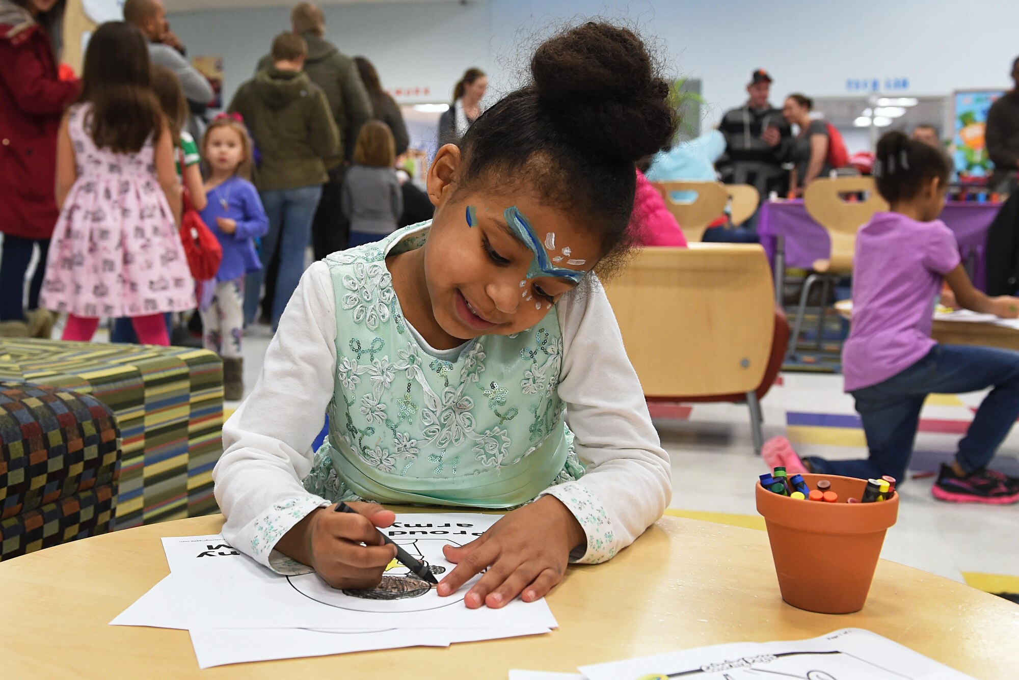 Erianah Reyes, 5, decorates a coloring page at the Month of the Military Child Kick-Off Celebration at the Illa School Age Center at Joint Base Elmendorf-Richardson, Alaska, March 31, 2017. The Month of the Military Child honors the important role military children play in the armed forces community. 