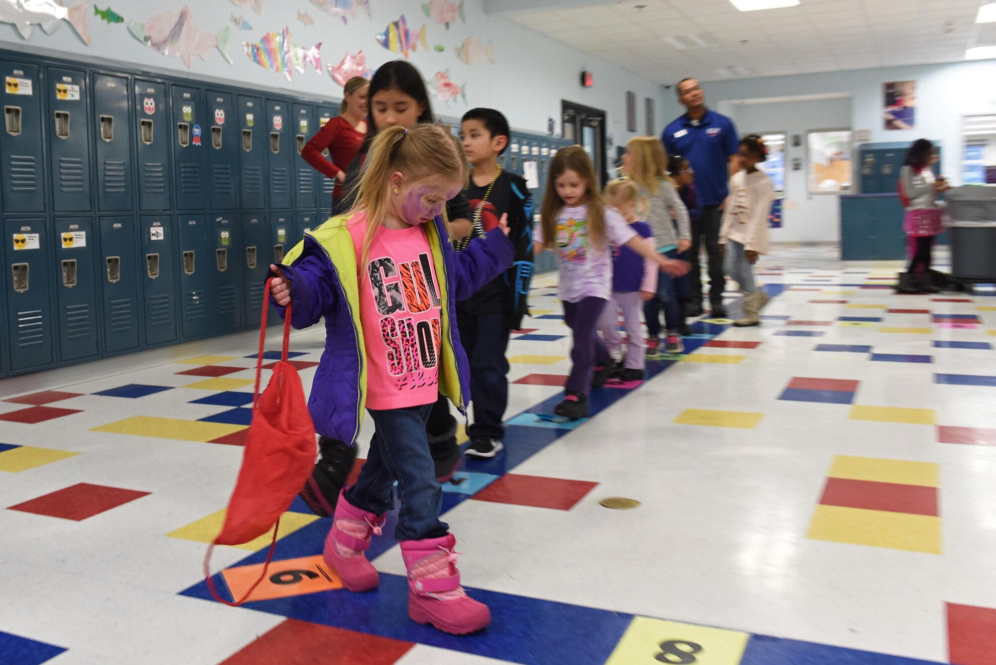 Chloe Charlton, 4, leads a line of children during a cupcake-walk at the Month of the Military Child Kick-Off Celebration at the Illa School Age Center at Joint Base Elmendorf-Richardson, Alaska, March 31, 2017. The Month of the Military Child honors the important role military children play in the armed forces community. 