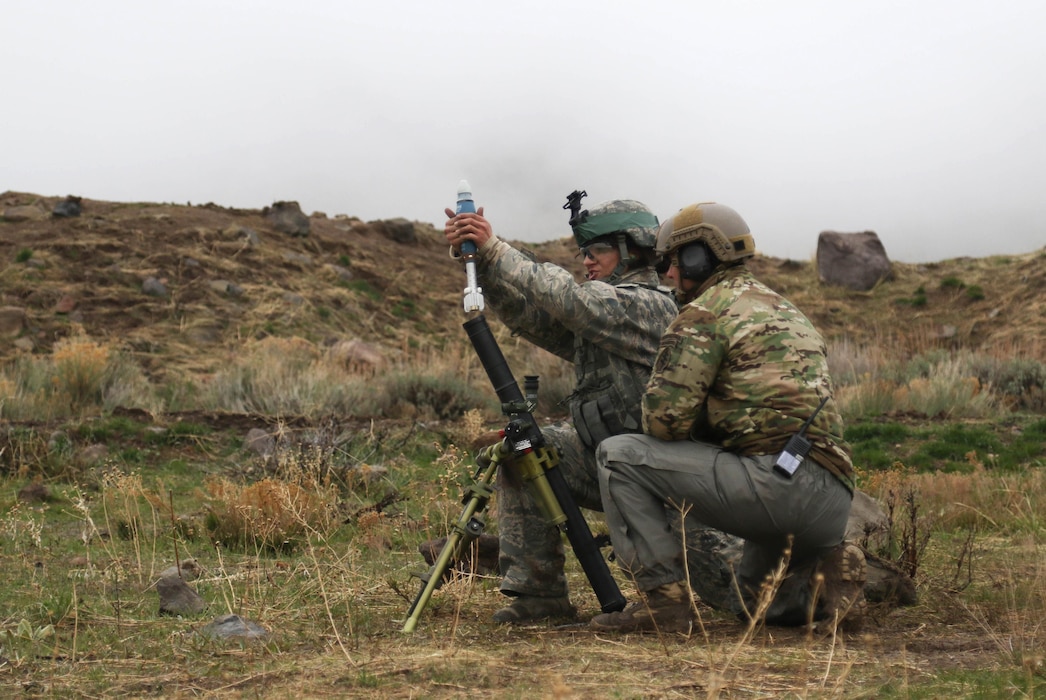 Airman 1st Class Kelley Barney, a member of the 151st Security Forces Squadron, prepares to fire a 60mm training round during the range run event at the Utah National Guard Best Warrior competition, at Camp Williams, Utah on April 8, 2017. (U.S. Army National Guard photo by Sgt. 1st Class Whitney Houston)