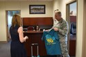 Ms. Laura Loftin, 301st Fighter Wing sexual assault response coordinator, hands out teal t-shirts to Tenth Air Force staff members in order to raise awareness of sexual assault and to empower members to take action in order
to prevent future assaults. This year&#39;s SAPR theme is &quot;Protecting our people protects our mission.&quot;  (U.S. Air Force photo by Maj. Rodney Ellison)