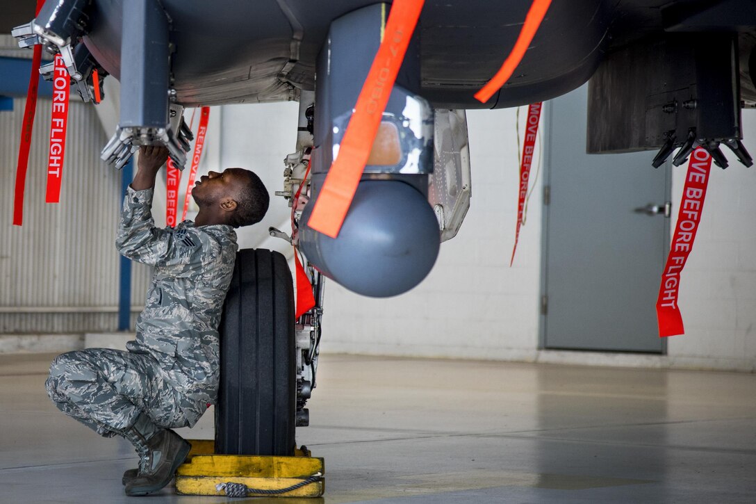 Air Force Senior Airman Aubrey Sloan performs pre-loading checks at the beginning of the Team Eglin weapons load competition at Eglin Air Force Base, Fla., April 7, 2017.  Teams assigned to the 96th Test Wing and 33rd Fighter Wing competed to see who could load two weapons onto aircraft the quickest and with the fewest errors. The 33rd Fighter Wing team won the event. Air Force photo by Samuel King Jr.