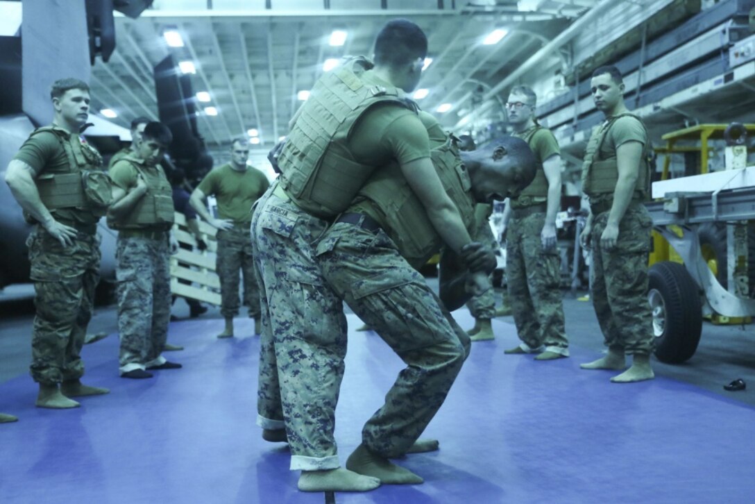 Sgt. Isaih Hart (left), a radio operator with Command Element, 31st Marine Expeditionary Unit, demonstrates a hip throw during Marine Corps Martial Arts Program training aboard the USS Bonhomme Richard (LHD 6), in the Pacific Ocean, March 12, 2017. Marines from each element of the 31st MEU underwent MCMAP training during the 31st MEU’s 17.1 Spring Patrol of the Asia-Pacific region. As the Marine Corps’ only continuously forward deployed unit, the 31st Marine Expeditionary Unit’s air-ground-logistics team provides a flexible force, ready to perform a wide range of military operations, from limited combat to humanitarian assistance operations, throughout the Asia-Pacific region. (U.S. Marine Corps photo by Sgt. Tiffany Edwards/Released) 