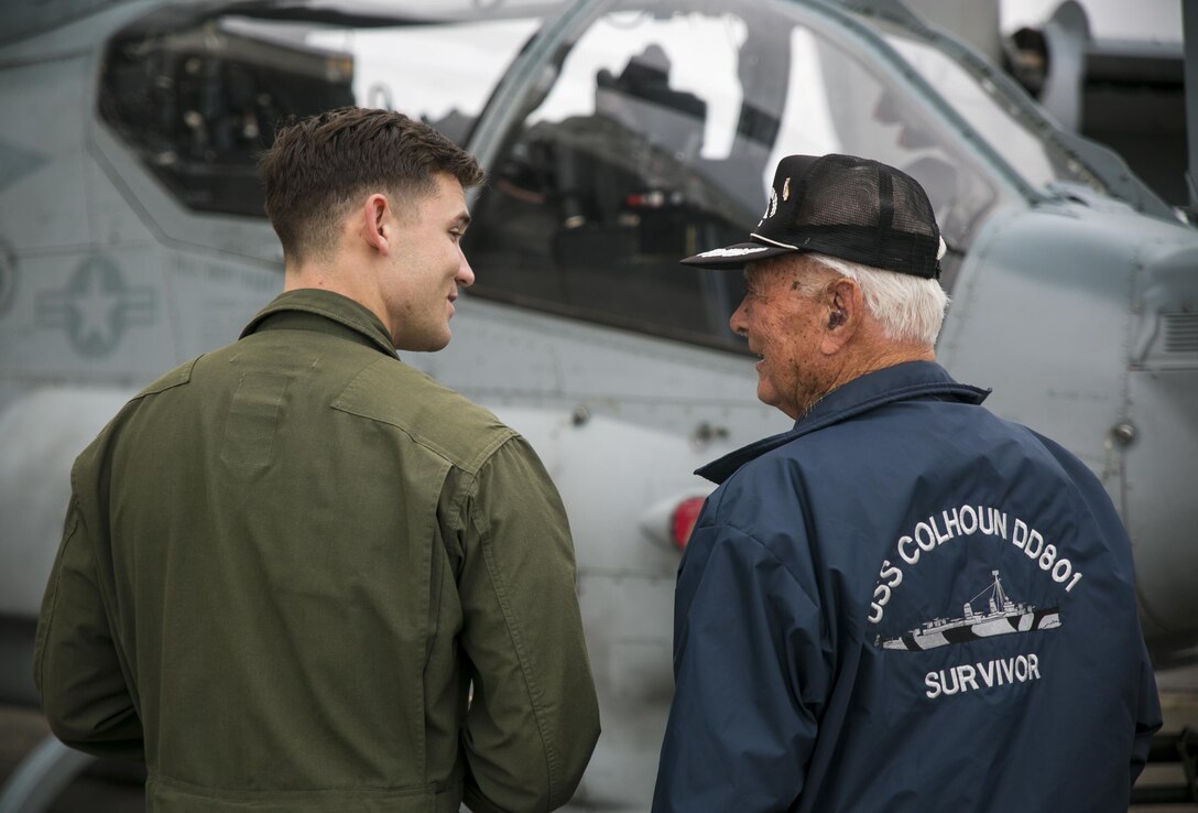 U.S. Marine Capt. Joe Hamlin gives Don Irwin, a United States Navy World War II veteran, a tour of the Bell AH-1Z Super Cobra, April 7, 2017 on Marine Corps Air Station Futenma, Okinawa, Japan. Irwin, who served aboard a number of ships during World War II, took part in battles for Midway and Guadalcanal and survived the sinking of the USS Calhoun during the battle for Okinawa. Irwin returned to Okinawa and exchanged stories with the Marines and Sailors stationed on the island. Irwin is a San Jose, California native and Hamlin, a Corbin, Kentucky, native, is a Bell AH-1 Super Cobra pilot with Marine Medium Tiltrotor Squadron 265, Marine Aircraft Group 36, 1st Marine Air Wing, III Marine Expeditionary Force. (U.S. Marine Corps photo by Cpl. Amaia Unanue)