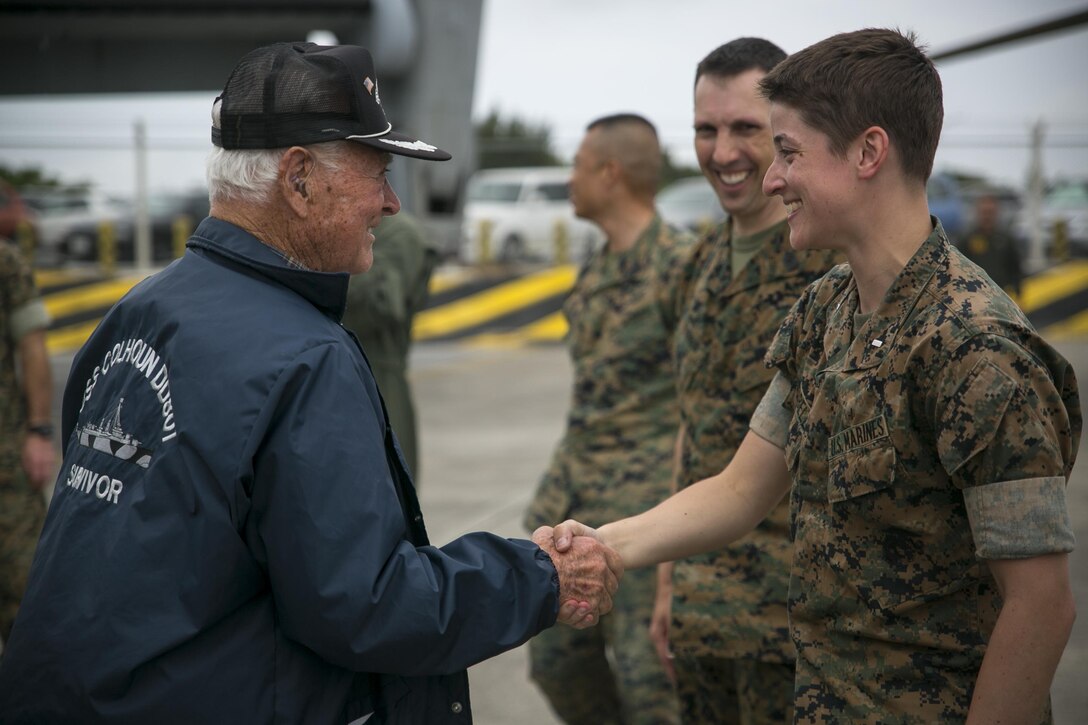 Don Irwin, a U.S. Navy veteran of World War II, shakes 1st Lt. Lauren Campbell’s hand April 7, 2017 on Marine Corps Air Station Futenma, Okinawa, Japan. Irwin, who served aboard a number of ships during World War II, took part in battles for Midway and Guadalcanal and survived the sinking of the USS Calhoun during the battle for Okinawa. Irwin returned to Okinawa and exchanged stories with the Marines and Sailors stationed on the island.Irwin is a San Jose, California native and Campbell, a Redwood City, California, native, is a material control officer with Marine Medium Tiltrotor Squadron 265, Marine Aircraft Group 36, 1st Marine Air Wing, III Marine Expeditionary Force. (U.S. Marine Corps photo by Cpl. Amaia Unanue)